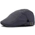 Detail of dark grey textured fabric with camouflage pattern and brass buckle on beret hat - Adjustable / Gray