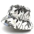 Detailed close-up of tropical palm leaf pattern and Paradise text on canvas bucket hat - M / White