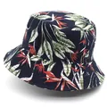 Detailed view of tropical floral print and cotton fabric texture on a navy blue bucket hat - M / Navy Blue