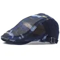Detail view of breathable mesh fabric and blue camouflage pattern on a flat cap - Navy Blue