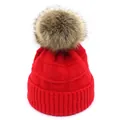 Detail view of red knitted beanie featuring a fluffy pompom and thick ribbed cuff texture - M / Red