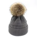 Detail of dark grey knit wool hat with textured check pattern and large brown pom-pom - M / Dark Gray