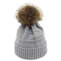 Close-up of light grey waffle knit beanie with fluffy faux fur pom-pom detail - M / Light Gray