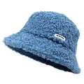 Detail shot of the soft teddy fleece texture and side label on a blue bucket hat - Blue