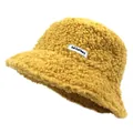 Close-up of yellow teddy fleece bucket hat featuring a white woven letter label - Yellow