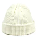 Close-up of ivory acrylic knit beanie showing thick ribbed texture and wide folded cuff - M / White