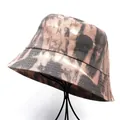Close-up of a tie-dye bucket hat in brown and black on a black wire display stand - M (56-58cm) / Brown Black Tie-dye