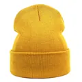 Close-up of the ginger yellow rib-knit texture and wide folded cuff of the acrylic beanie - M (56-58cm) / Gold