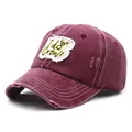 Detailed view of the distressed burgundy cotton baseball cap with I do Crew embroidery - M / Burgundy