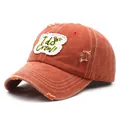 Detailed macro view of the distressed brick red cotton baseball cap with I do Crew embroidery - M / Orange