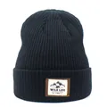 Detailed close-up of a black ribbed knit beanie featuring a mountain adventure fabric patch - M (56-58cm) / Black