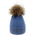 Detailed knit texture and brown faux fur pom-pom on a blue winter beanie with star patterns - M (56-58cm) / Blue