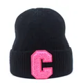 Detail of black ribbed knit beanie featuring a pink bouclé embroidered letter C patch - Black