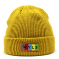 Close-up of ginger yellow ribbed knit beanie featuring a colorful WYLS letter patch - M / Yellow