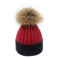 Detail of red and black ribbed knit beanie with a fluffy raccoon fur pom-pom on top - M (56-58cm) / Wine Red + Black