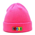 Close-up of bright pink knitted beanie featuring a colorful WYLS letter patch detail - M / Rose Red