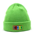 Detail of green ribbed knit beanie showing colorful rubber patch with WYLS lettering - M / Green