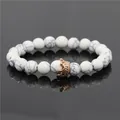White turquoise bead bracelet with rose gold crown charm on mirror background - Howlite Crown