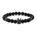 Macro view of matte black onyx beads with micro-paved crown pendant detail on men's bracelet - Black Stone Black Crown