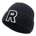 Close-up of black knitted beanie featuring thick honeycomb texture and letter R patch - M / Black