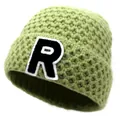 Detailed macro view of the avocado green knitted texture and embroidered R letter patch - M / Green