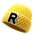 Close-up of bright yellow knitted beanie featuring a bold letter R patch embroidery - M / Yellow