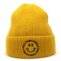 Close-up of yellow knitted beanie featuring detailed smile embroidery and soft wool texture - M (56-58cm) / Yellow