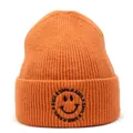 Close-up of bright orange knit beanie showing detailed texture and smile embroidery - M (56-58cm) / Orange