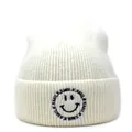 Detail of smile face embroidery and 'SMILE' text on cream knitted beanie hat - M (56-58cm) / White