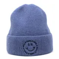Detail of blue ribbed knit beanie with black smile embroidery and smile text pattern - M (56-58cm) / Blue