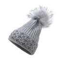 Close-up of grey knit beanie with fluffy faux fur pompom and silver glitter star details - M / Gray