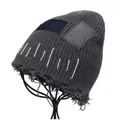 Detail view of distressed dark grey knit beanie featuring vintage denim patches and fringe - M (56-58cm) / Gray