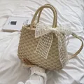 Sac en paille tissé beige orné d'un grand nœud en dentelle blanche et broderie florale - Beige