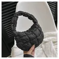 Detail of black quilted cloud bag showing soft padded nylon texture and integrated handle - Black