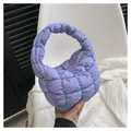 Detail of purple quilted cloud bag showing soft texture, top zipper and curved handle - Purple