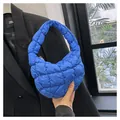 Close-up of royal blue quilted bubble handbag showing soft texture and puffy design - Dark Blue