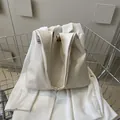 Minimalist cream white soft PU leather tote bag with stylish side woven label detail - White