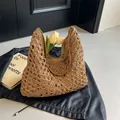 Brown woven hollow knit tote bag with leather straps on a vintage background - Solid Khaki