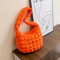 Bright orange quilted bubble shoulder bag with a padded crossbody strap and zip closure - Orange