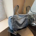 Cylindrical washed blue denim shoulder bag with vertical quilting and long strap - Dark Blue