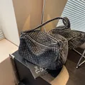Quilted washed denim shoulder bag in charcoal black with metallic zipper and reinforced strap - Black