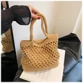 Close-up of crochet mesh pattern and secure inner lining on the beige beach tote bag - Khaki