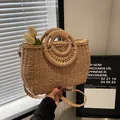 Light brown woven straw bag with ring handles and a long detachable shoulder strap - Khaki