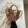 Handwoven straw shoulder bag with pink hello lettering and floral scarf handle - Pink