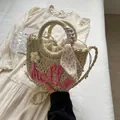Straw handbag with pink 'hello' embroidery and floral scarf handle in light beige - Rose Pink