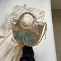 Straw handbag with blue hello embroidery, floral scarf, and 3D flower detail - Blue