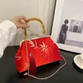 Elegant red Chinese style handbag with golden bamboo embroidery and bamboo handle - Red