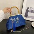Retro dark blue satin handbag with gold bamboo leaf patterns and natural bamboo handle - Blue