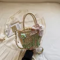 Woven straw handbag with green hello text and pink floral bow for summer beach vacations - Green