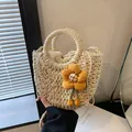 Woven straw handbag in beige with yellow flower charm and drawstring liner - Matte Cream White Sunflower